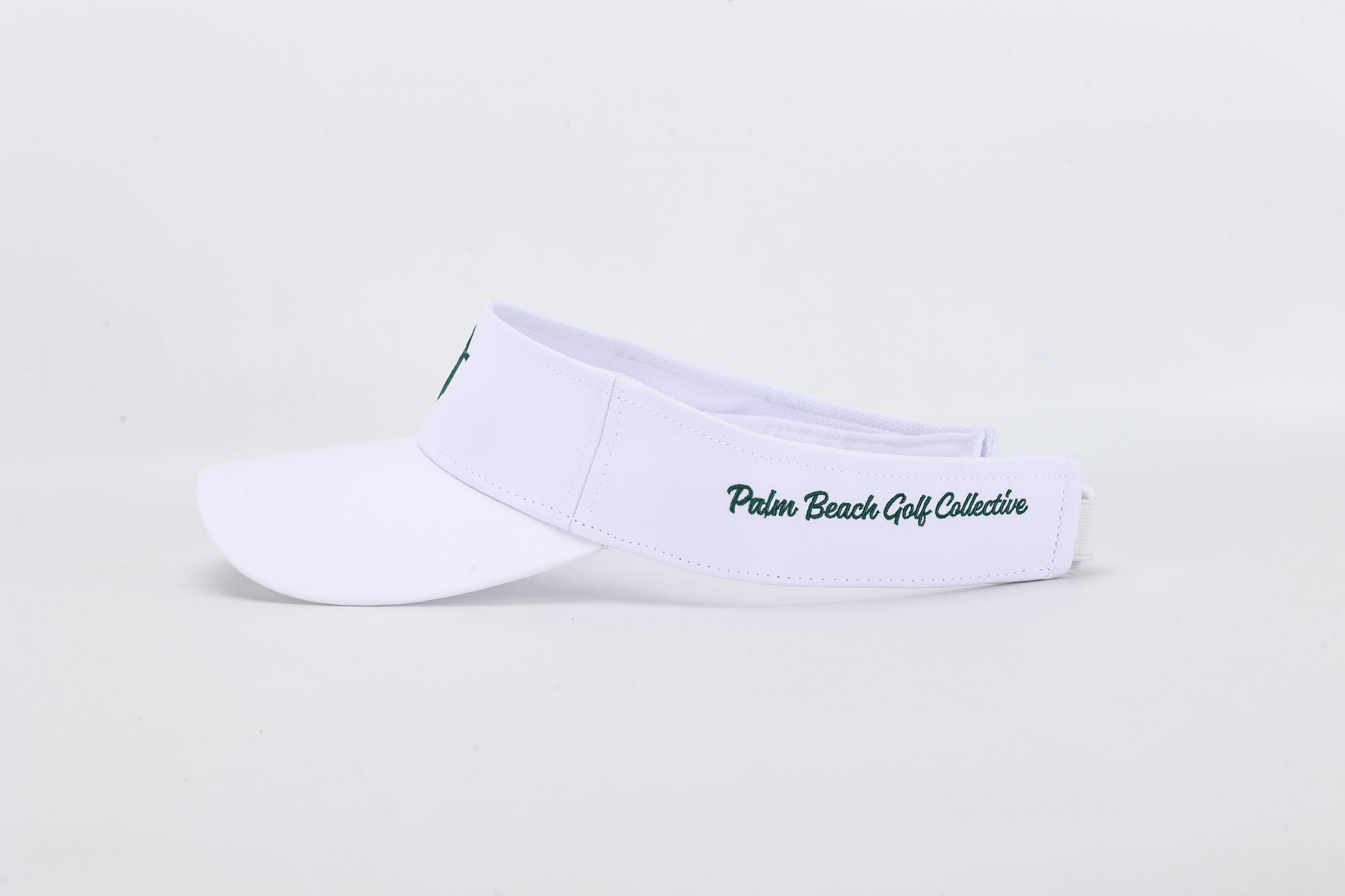 White visor with "Palm Beach Golf Collective" text on a light gray background
