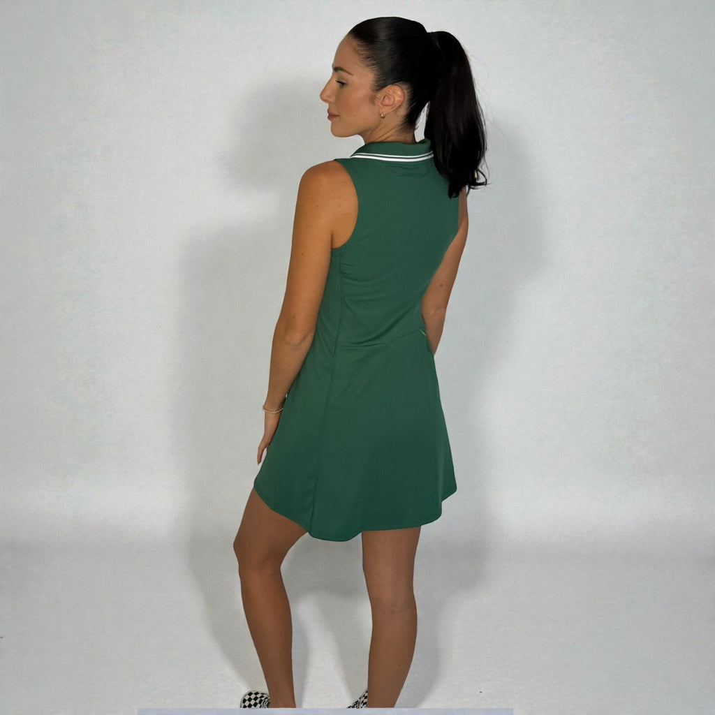 Woman wearing a green dress against a plain background