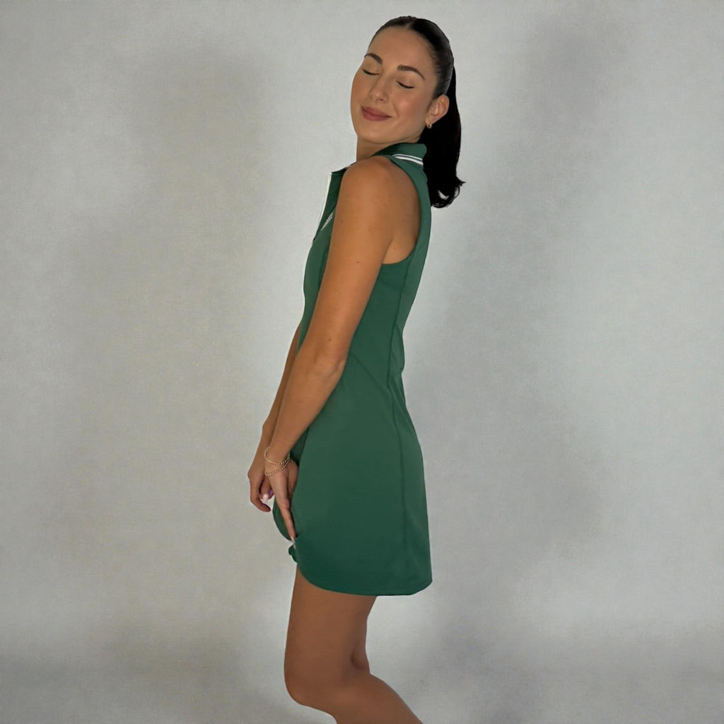 Woman wearing a green dress against a plain background