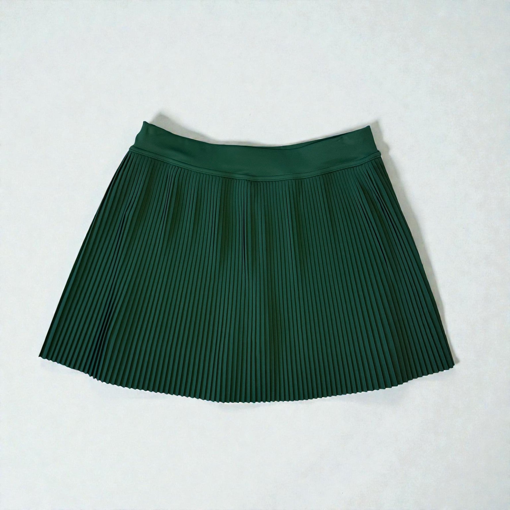 Green pleated skirt on a white background