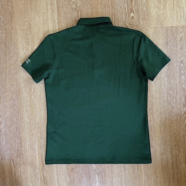 Back view of a PBGC forest green performance golf polo shirt with short sleeves and a structured collar.