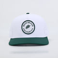 PBGC The Palm Patch Hat featuring a white crown, green bill, and circular embroidered palm tree logo patch.