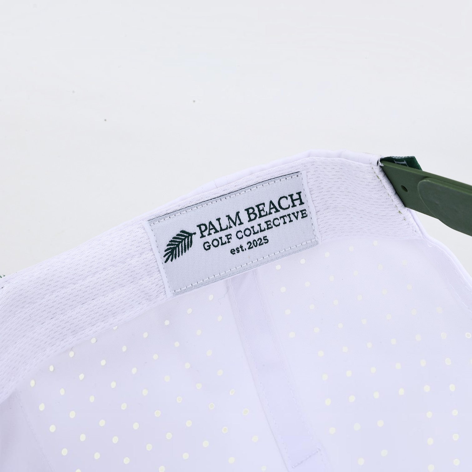 Interior view of a PBGC Palm Patch Hat featuring a white perforated crown and a branded woven label.