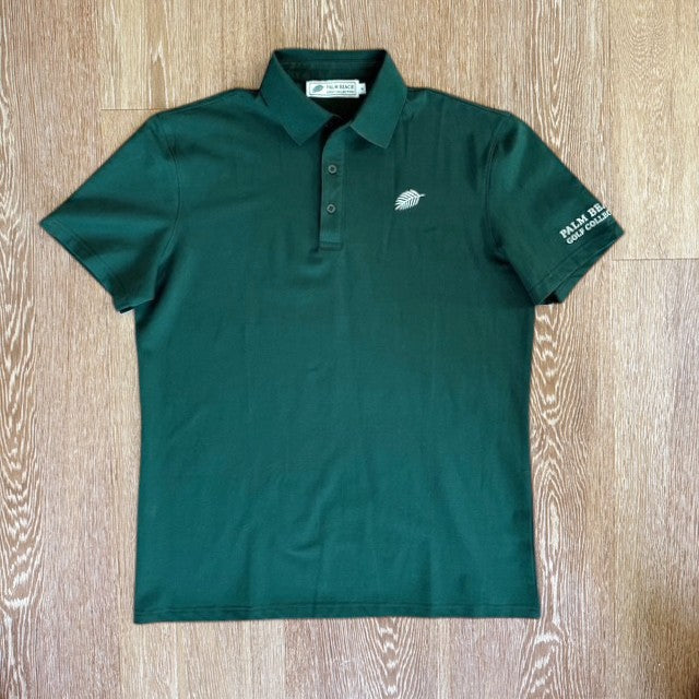 PBGC Pure Strike dark green golf polo shirt with a small leaf logo on the chest and branding on the sleeve.