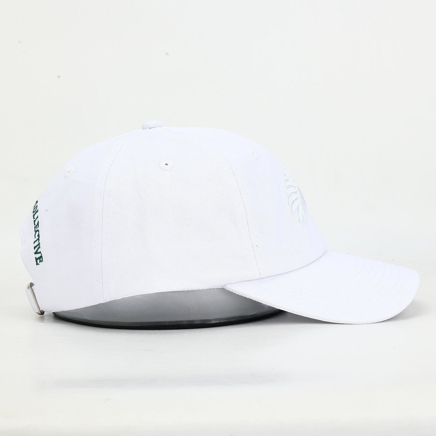 PBGC white cotton twill baseball cap with tonal fern embroidery and side text detail, side profile view.