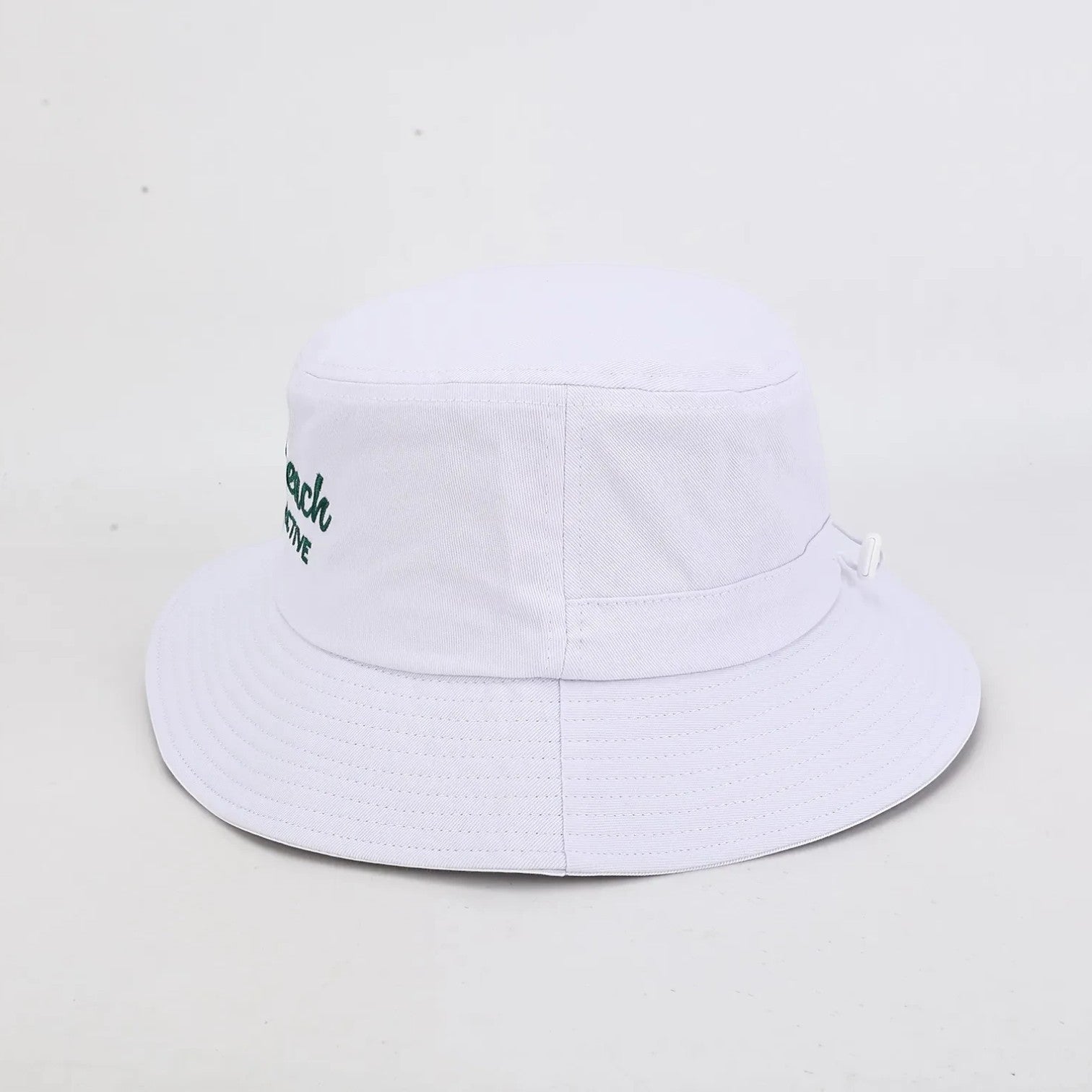 PBGC white bucket hat with green embroidered branding and adjustable chin strap for golf sun protection