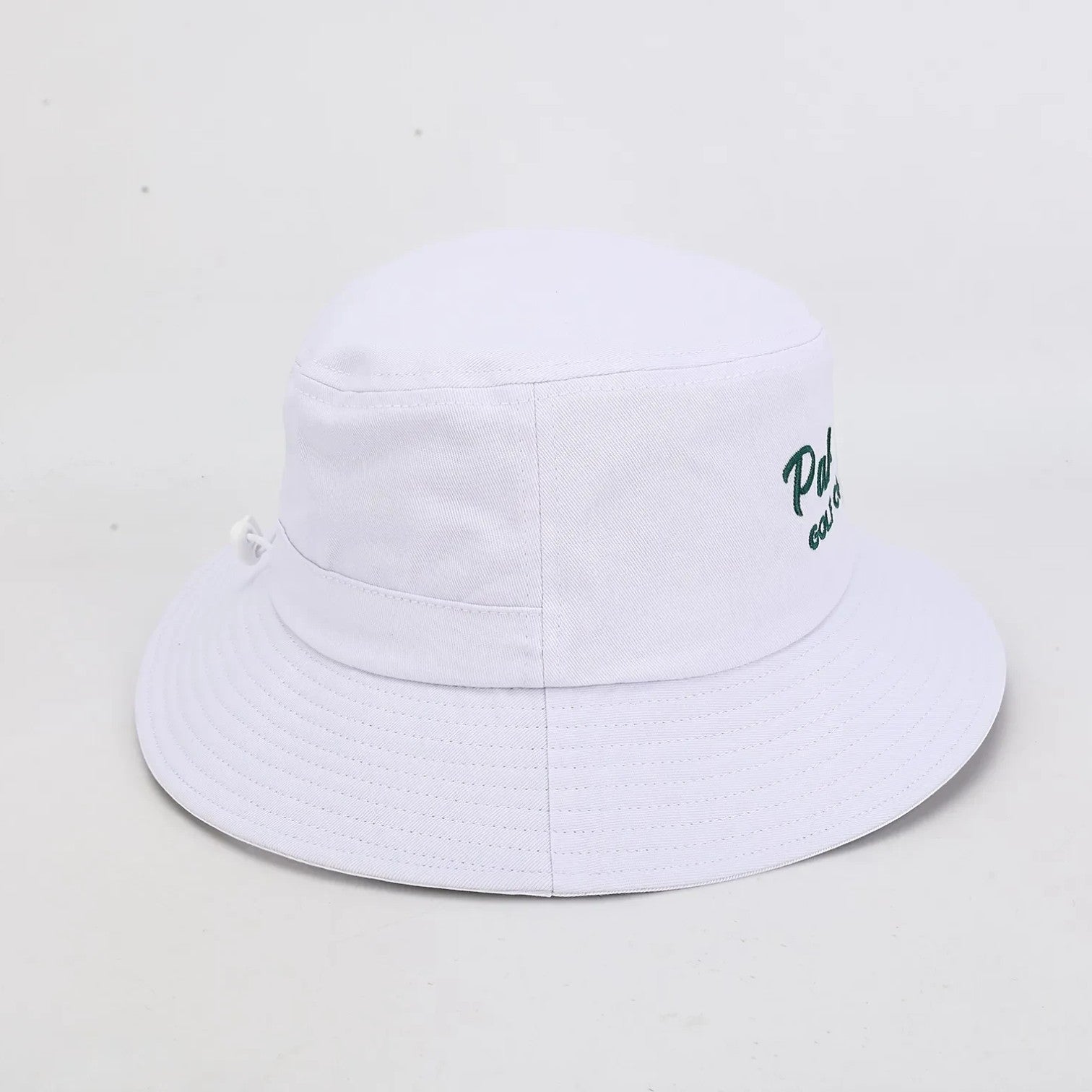 PBGC white bucket hat with green embroidered logo, featuring breathable fabric for golf sun protection.