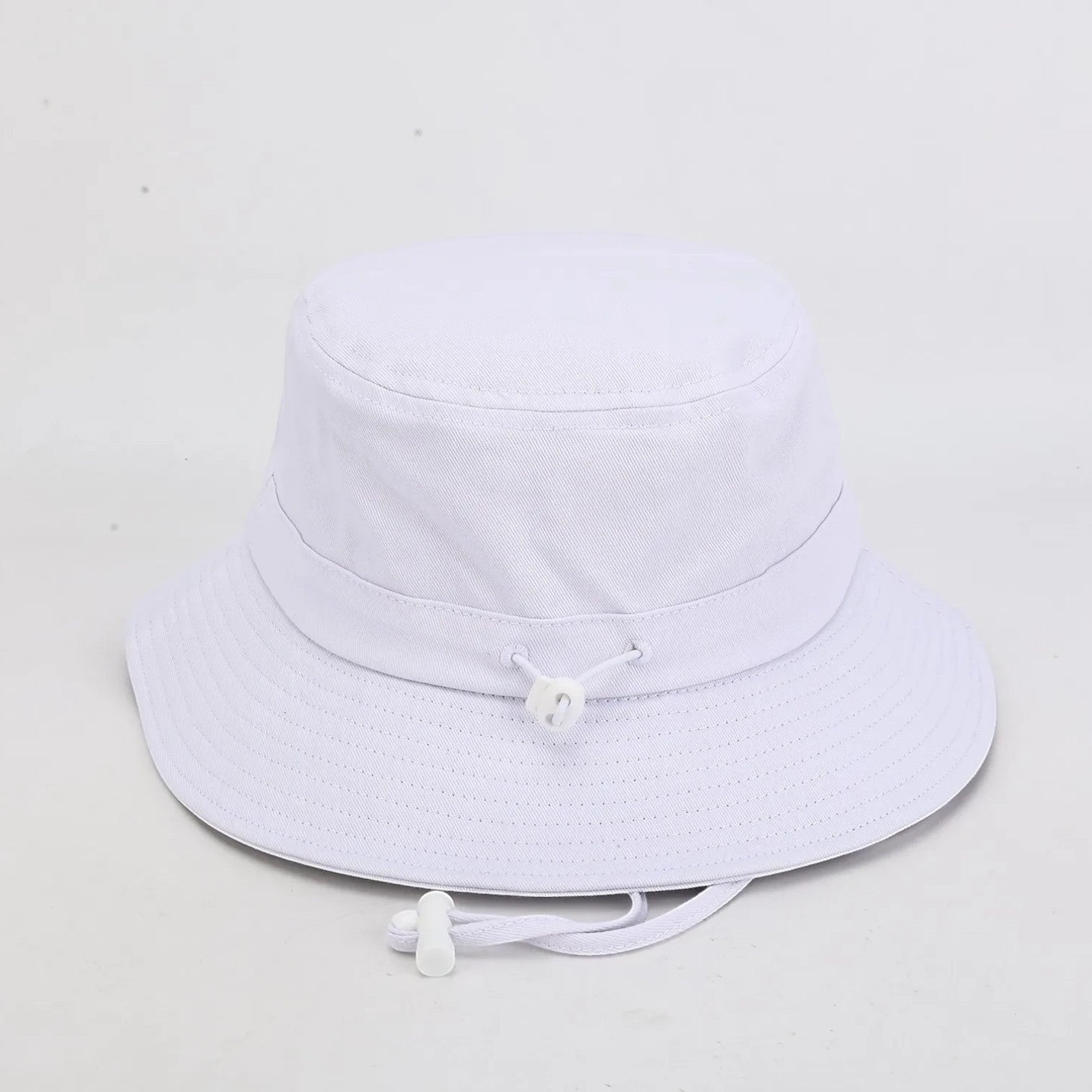 PBGC white bucket hat with an adjustable chin strap, perfect for sun protection on the golf course.