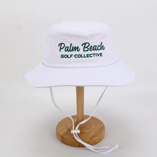 PBGC white bucket hat with green Palm Beach Golf Collective embroidery and adjustable chin strap for golf.