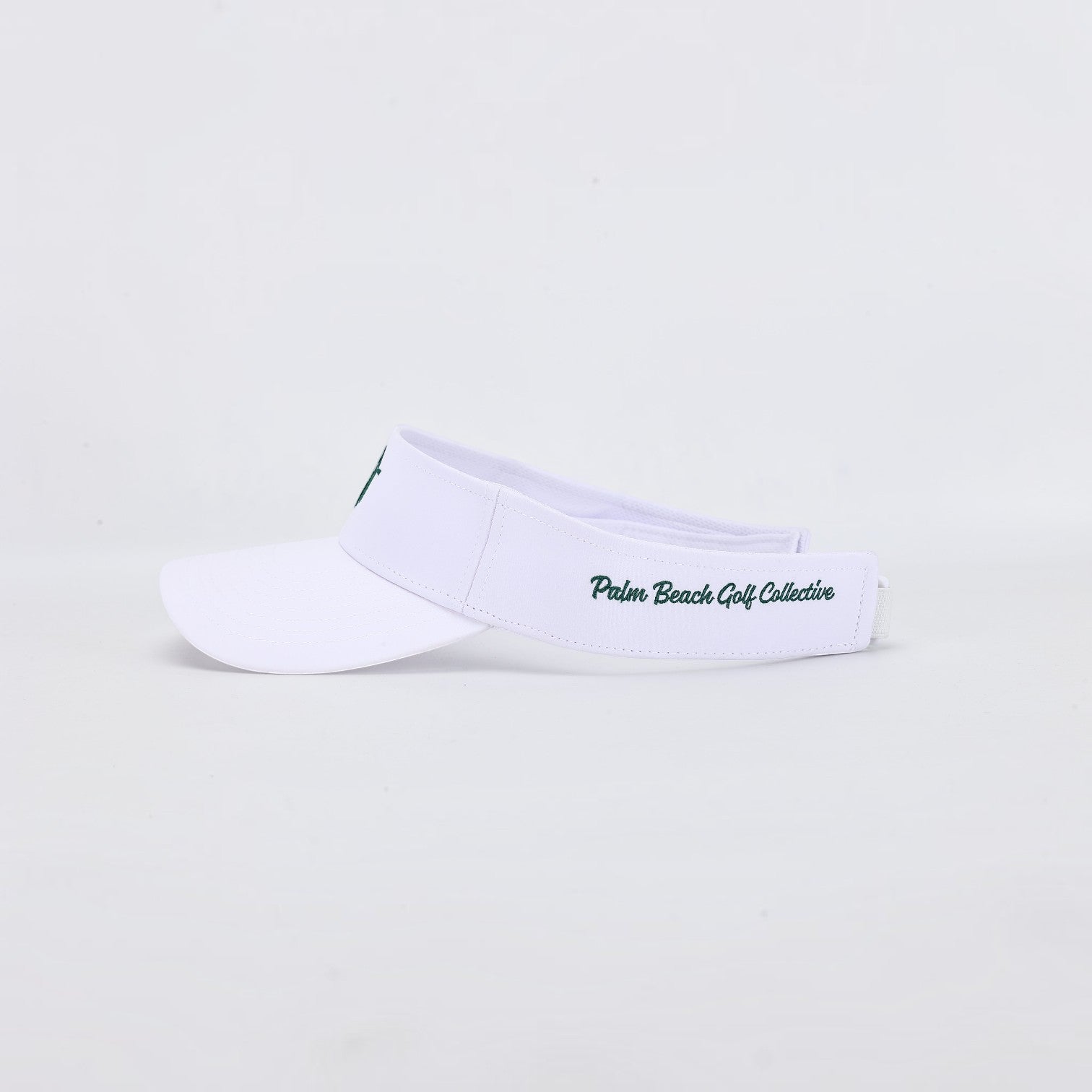 PBGC The Island Visor in white with green embroidered branding on the side, designed for golf and sunny days.