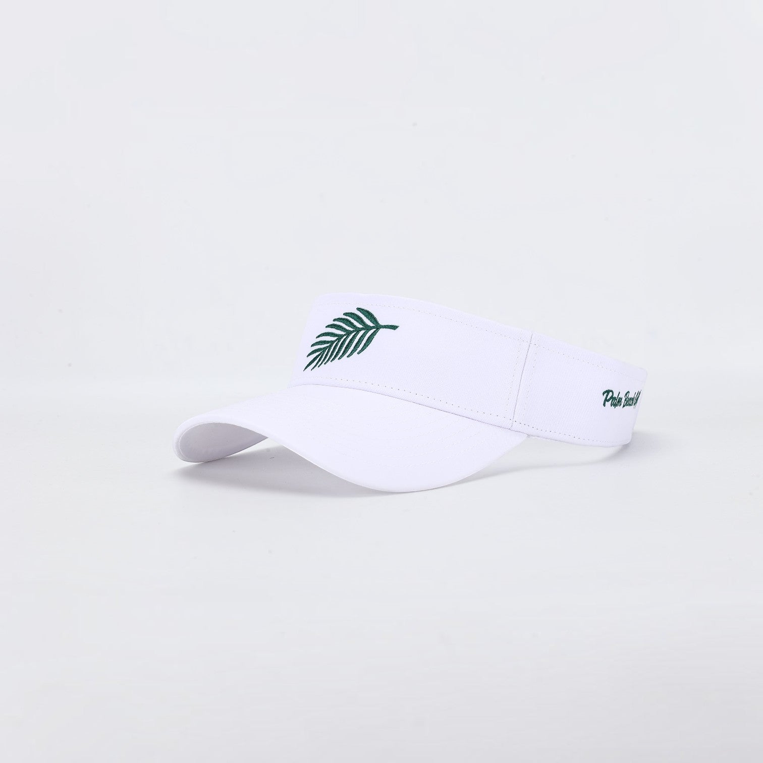 PBGC The Island Visor in white with a green palm leaf embroidery on the front and side logo detail.
