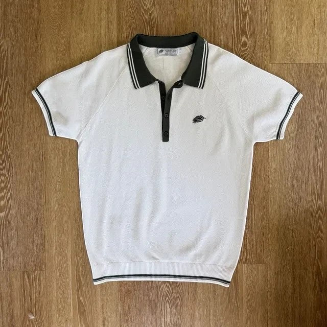 PBGC Course Record knit polo shirt in white with dark green collar, button placket, and leaf logo embroidery.