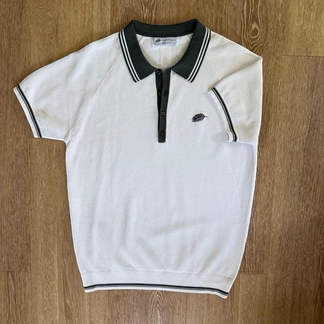 PBGC Course Record Knit Polo in white with dark green collar, button placket, and sleeve trim with palm leaf logo.