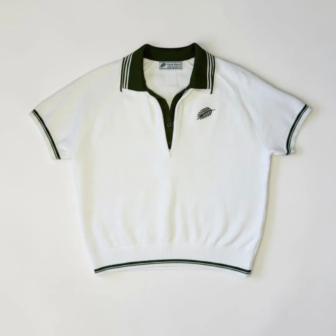 PBGC white knit polo sweater with olive green collar, placket, and palm leaf embroidery on a white background.